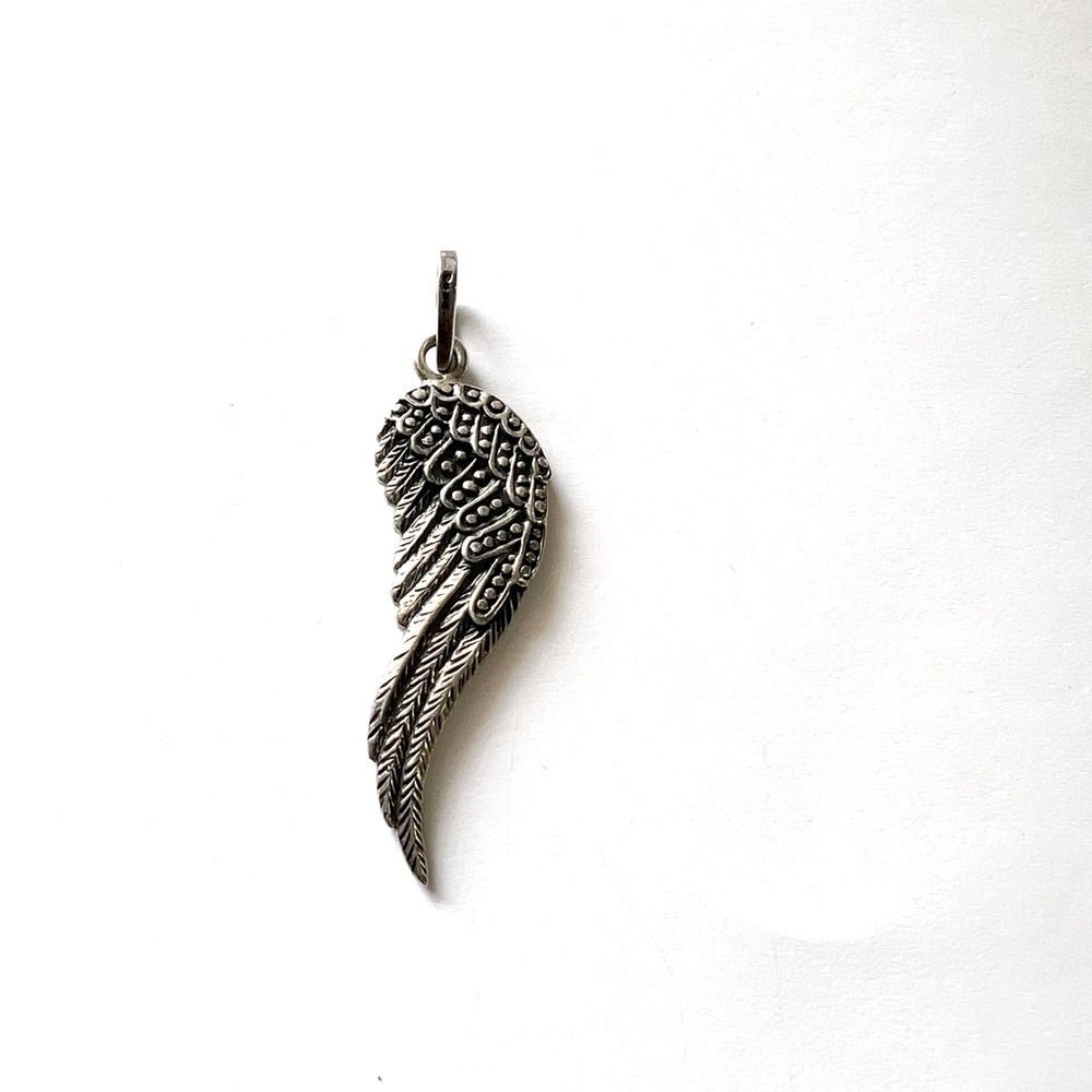 Silver wing charm.